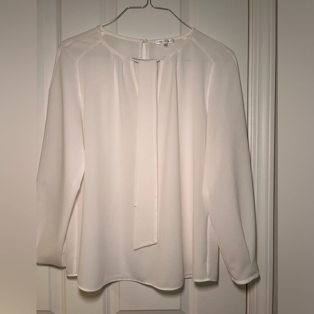 White blouse with keyhole detail and a bow tie